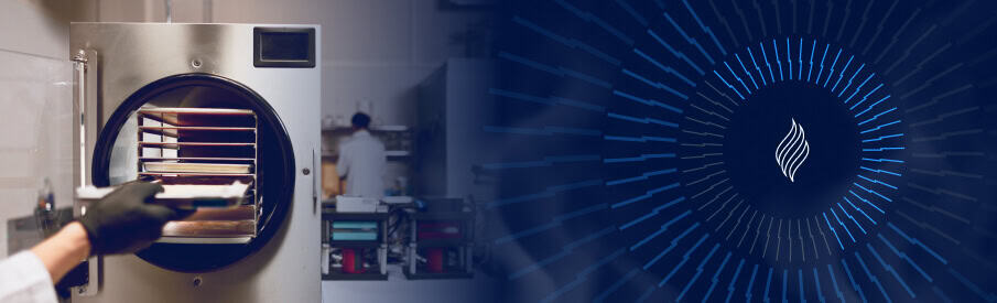 Laboratory incubator with open door showing shelves, technician working in background, and blue.